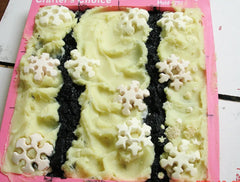 Silicone mold with green textured soap, snowflake shapes, and dark sections for Mauna Kea soap challenge