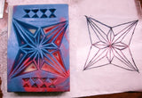Relief carving of a star design in red and blue on carved soap using wood chip carving and craft knife