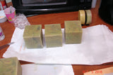 Rough-cut olive green soap bars showcasing wood grain technique for Lisa’s Natural soap challenge