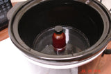 Slow cooker with infused oil and small brown bottle for Tangerine Dancing Funnel Swirl Soap