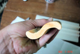Smooth S-shaped light-colored carving representing dancing funnel swirl infused oil in Lisas Natural article