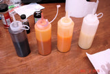 Squeeze bottles with colorful liquids for Tangerine Dancing Funnel Swirl soap infused oil