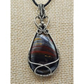 The Earth-Core Sentinel - pendant has a tear drop tirger iron cabachon wire wrapped in sterling silver