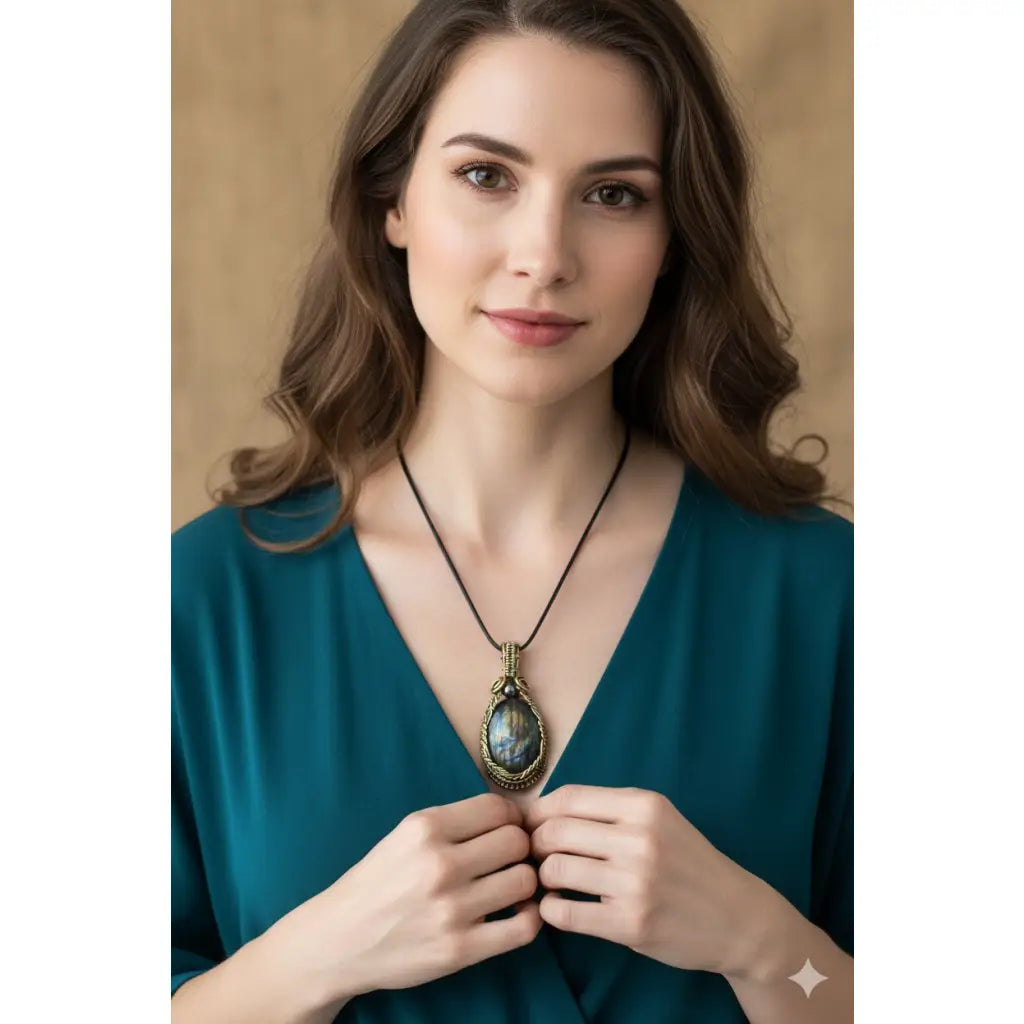 A woman wearing a jandmade wire wrapped Labradorite & Red Brass pendant on a cord. High labradorescense showing on the labradorite. Scrolling Brass Braided wire with a hematite accent bead 