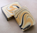 Two handcrafted swirled soap bars from the Great Cakes Soap Challenge showcasing a unique soap recipe