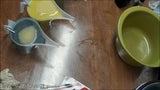Two pitchers pouring liquid on wood surface for Lisa’s Natural soap challenge with wood grain technique