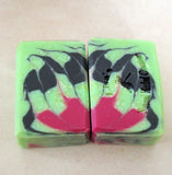 Two swirled soap bars in green black and pink for Great Cakes Soap Challenge