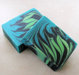 Handmade soap bars with swirling blue, green, and black patterns from Great Cakes Soap Challenge