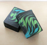 Two soap bars with green, blue, and black swirls from Great Cakes Soap Challenge