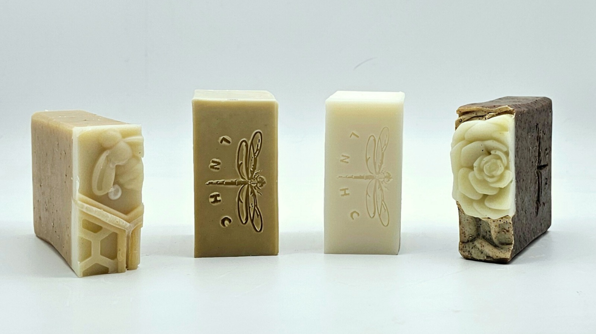Left to right: Unscented Soaps, Oats & Honey Goat Milk Coconut & Palm Free Soap, Extra Virgin Olive Oil Soap with Honey, Coconut & Palm Free Soap , Cocoa Banana Exfoliating Soap with Soybean Meal JPG