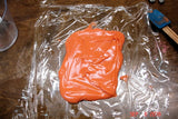 Vibrant orange frosting or dough for soap challenge with oatmeal milk and shea butter