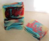 Vibrantly swirled soap bars with blue, red, and yellow colors from the Great Cakes Soap Challenge